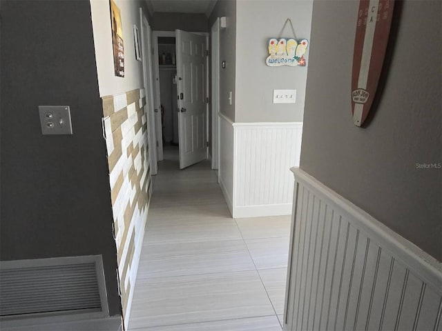 hall featuring a wainscoted wall