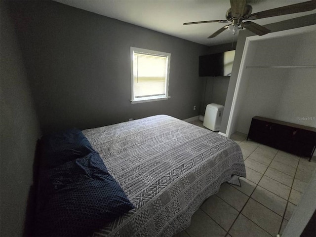 tiled bedroom featuring a ceiling fan