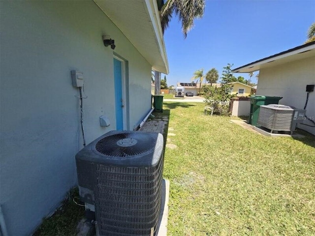 view of grassy yard featuring central AC unit