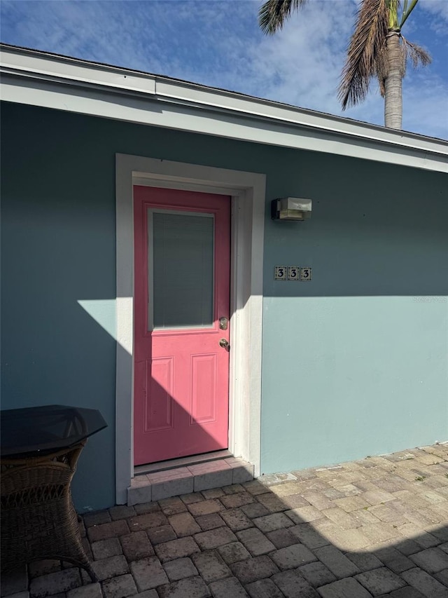doorway to property with stucco siding