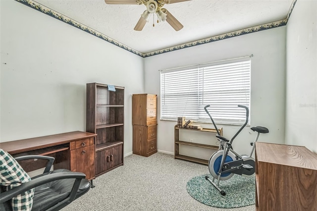 office area featuring light colored carpet, a ceiling fan, and baseboards