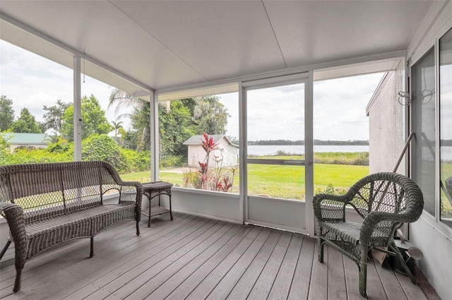 sunroom with a water view and plenty of natural light