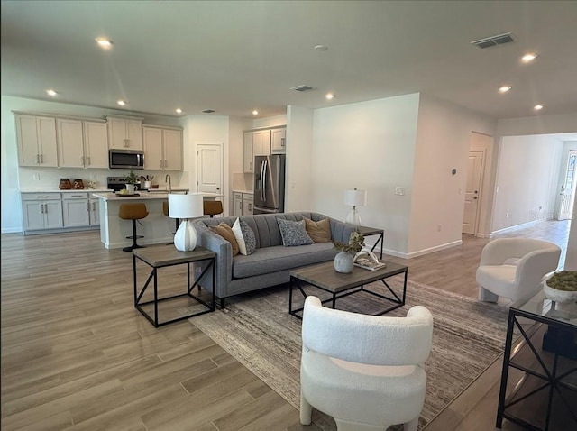 2681 Ginseng Ivy St, Apopka, FL 32703 - living area featuring light wood finished floors and recessed lighting