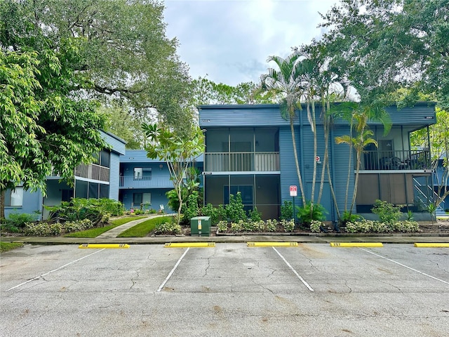 view of property featuring uncovered parking
