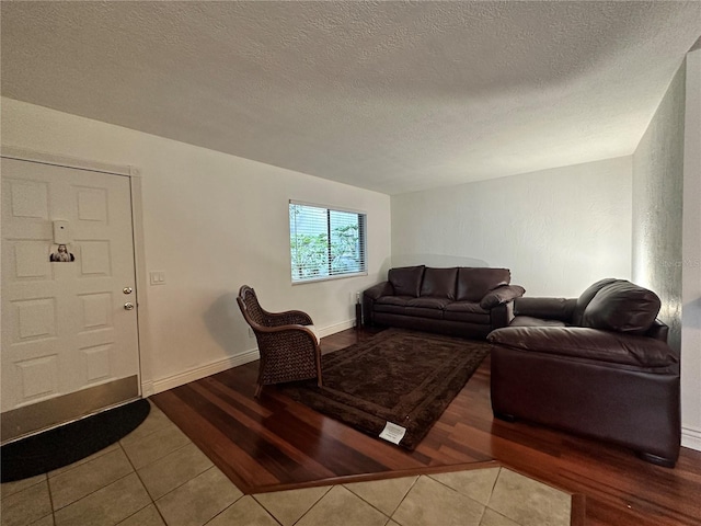 tiled living area with a textured ceiling