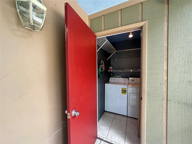laundry area with independent washer and dryer and tile patterned flooring