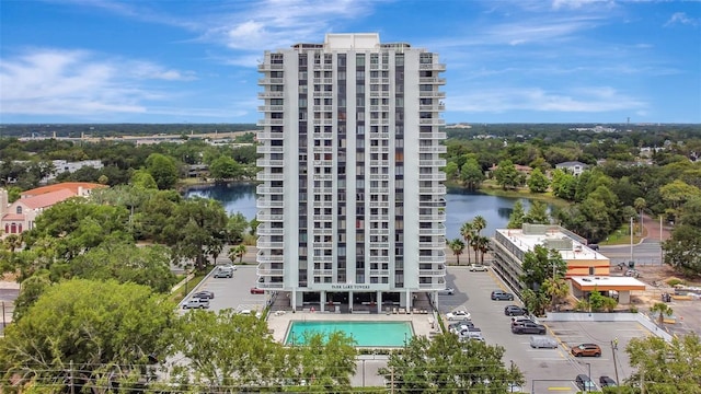 view of apartment building / complex featuring a water view and uncovered parking