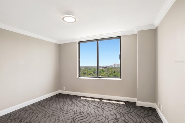 unfurnished room featuring crown molding, baseboards, and dark colored carpet