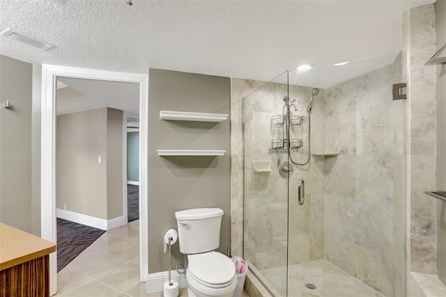 bathroom with a stall shower, toilet, baseboards, a textured ceiling, and vanity