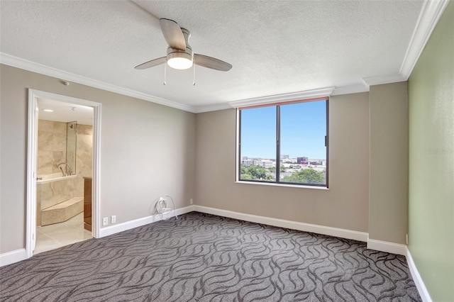 spare room with carpet, baseboards, ornamental molding, a ceiling fan, and a textured ceiling