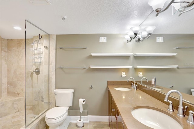 full bathroom with toilet, tiled shower, double vanity, baseboards, and a chandelier