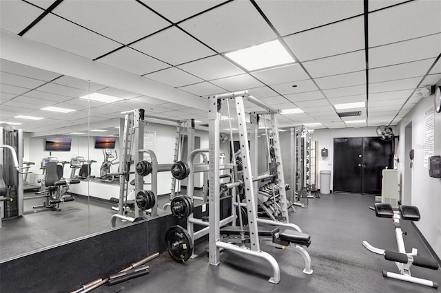 exercise room with a paneled ceiling