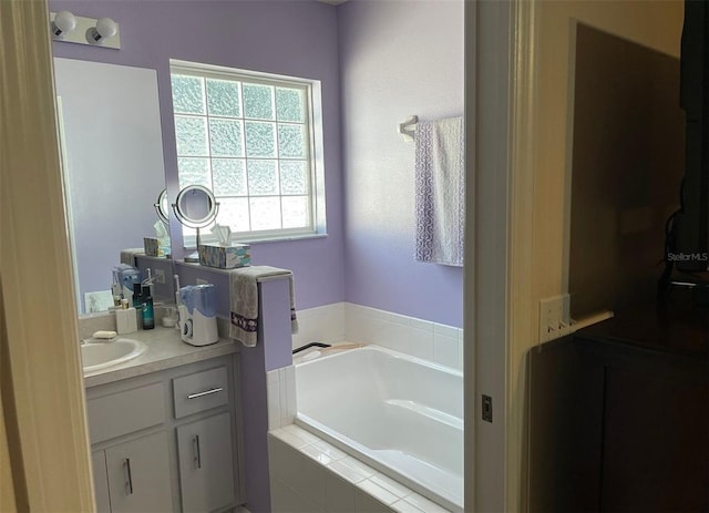 full bathroom with vanity and a bath