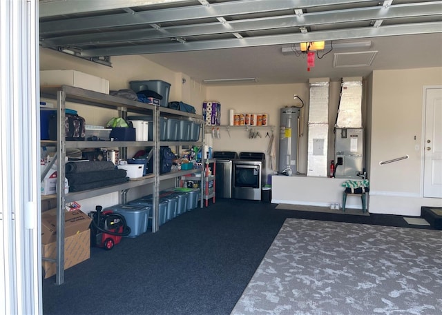 garage featuring independent washer and dryer, water heater, and heating unit
