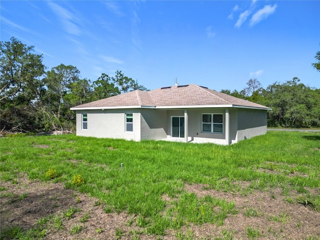 16253 SW 29th Court Rd, Ocala, FL 34473 - back of house with stucco siding and a lawn