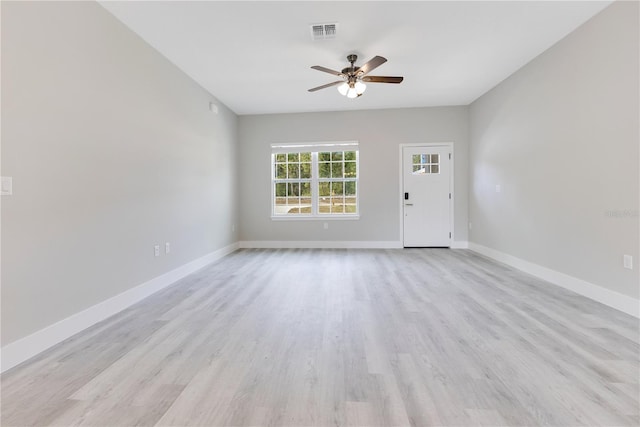 unfurnished living room featuring a ceiling fan, light wood finished floors, and baseboards