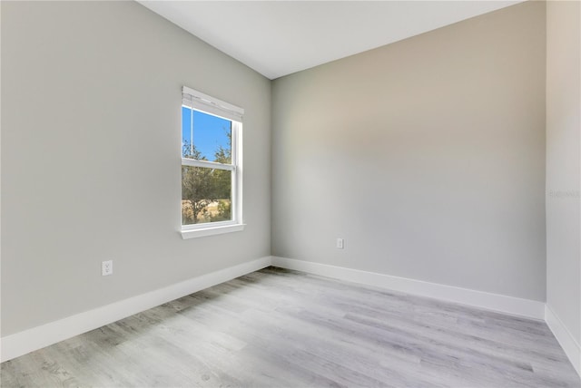spare room with light wood finished floors and baseboards