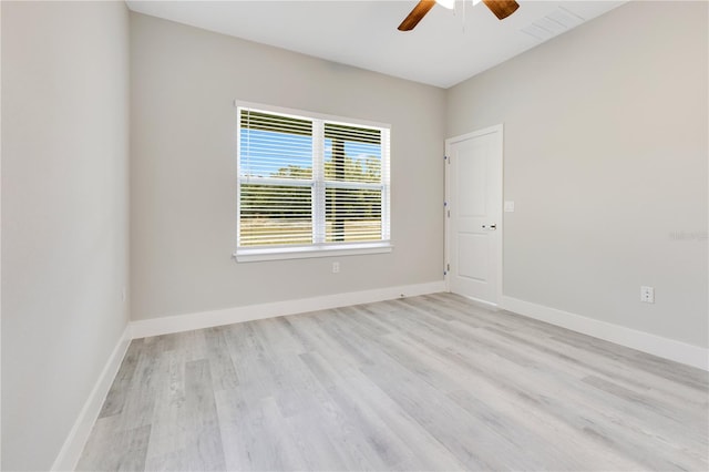 unfurnished room with ceiling fan, wood finished floors, and baseboards