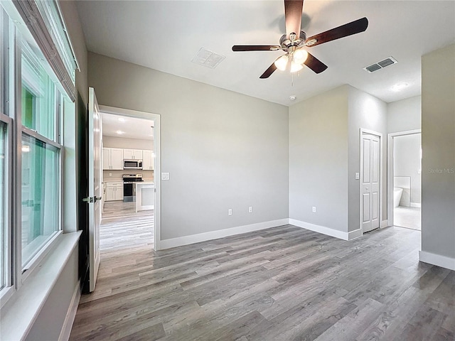 2531 SW 167th Loop, Ocala, FL 34473 - unfurnished room with a ceiling fan, light wood-type flooring, and baseboards
