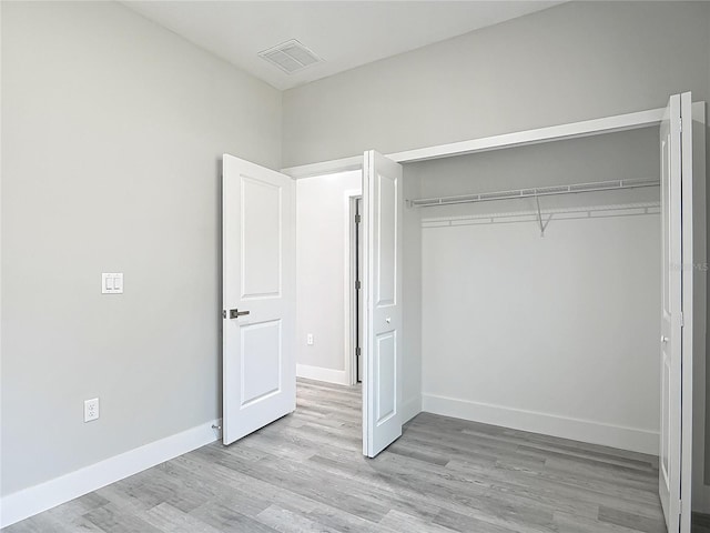 2531 SW 167th Loop, Ocala, FL 34473 - unfurnished bedroom with a closet, light wood finished floors, and baseboards