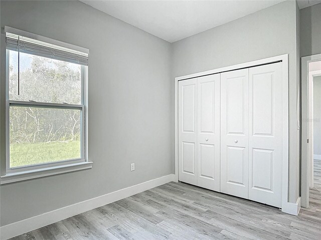 2531 SW 167th Loop, Ocala, FL 34473 - unfurnished bedroom featuring light wood-type flooring, baseboards, and a closet