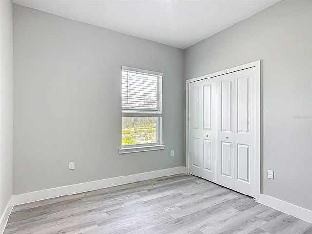 2531 SW 167th Loop, Ocala, FL 34473 - unfurnished bedroom with light wood-style floors, baseboards, and a closet