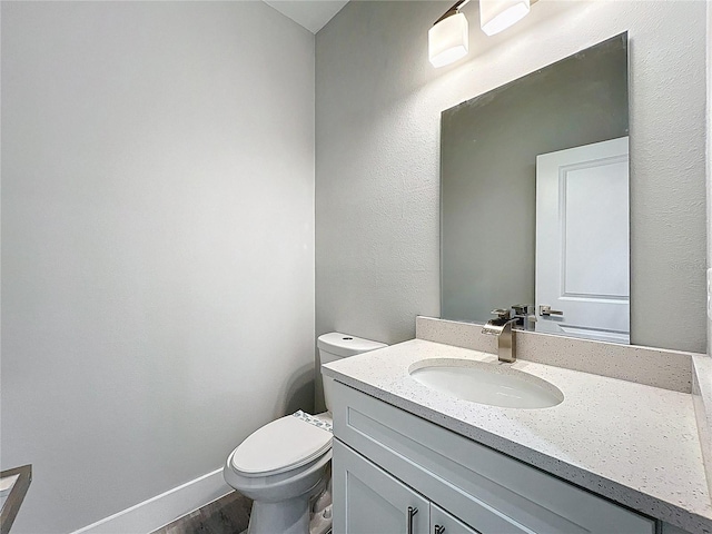 2531 SW 167th Loop, Ocala, FL 34473 - bathroom with toilet, wood finished floors, vanity, and baseboards