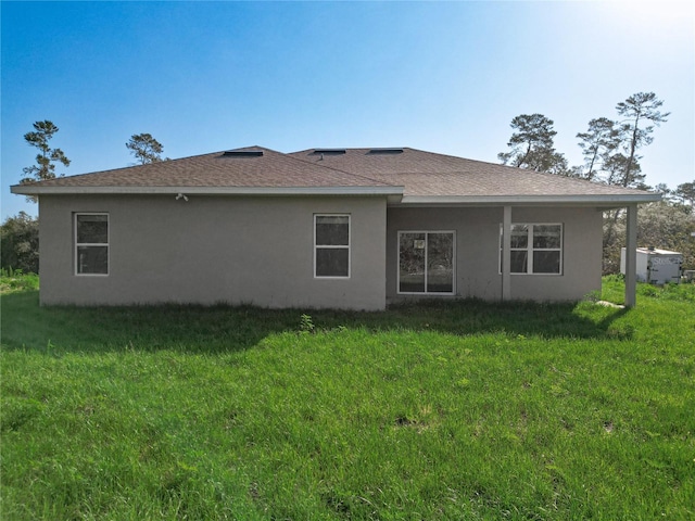 2531 SW 167th Loop, Ocala, FL 34473 - back of property with stucco siding, a lawn, and roof with shingles