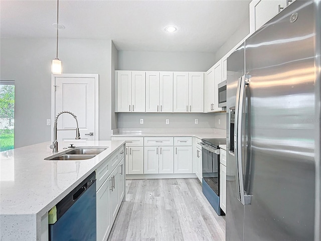 2531 SW 167th Loop, Ocala, FL 34473 - kitchen with appliances with stainless steel finishes, a sink, light wood-style floors, and white cabinetry
