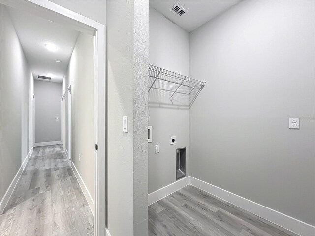 2531 SW 167th Loop, Ocala, FL 34473 - laundry room featuring hookup for an electric dryer, light wood finished floors, washer hookup, and baseboards