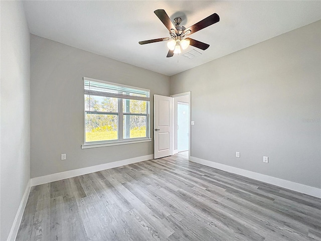 2531 SW 167th Loop, Ocala, FL 34473 - spare room featuring wood finished floors, a ceiling fan, and baseboards