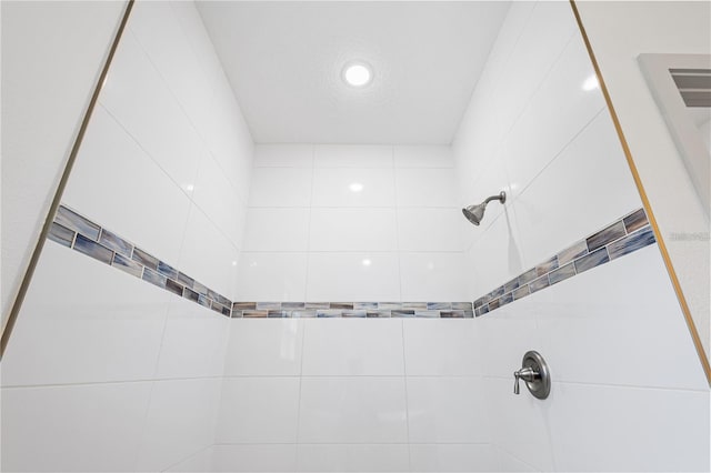 bathroom featuring a tile shower and recessed lighting