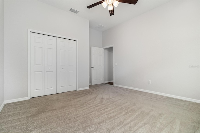 unfurnished bedroom featuring carpet flooring, a closet, a ceiling fan, and baseboards