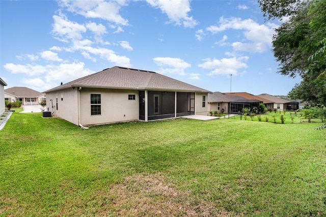 rear view of property featuring a sunroom, stucco siding, and central AC unit