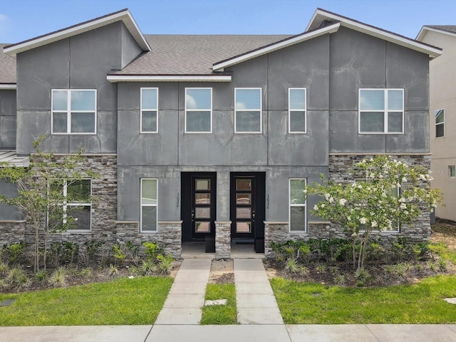 1632 Tropical Palms Cir, Kissimmee, FL 34747 - contemporary home featuring stone siding, stucco siding, and a shingled roof