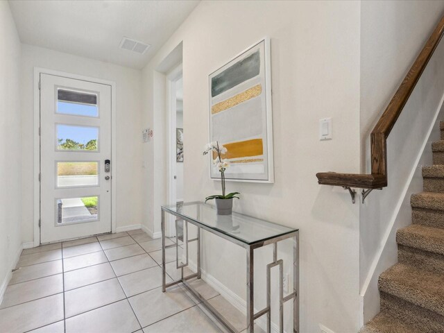 1632 Tropical Palms Cir, Kissimmee, FL 34747 - foyer featuring stairs, light tile patterned floors, and baseboards