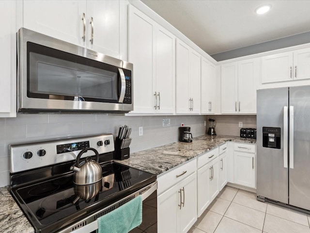 1632 Tropical Palms Cir, Kissimmee, FL 34747 - kitchen with appliances with stainless steel finishes, white cabinets, backsplash, and recessed lighting