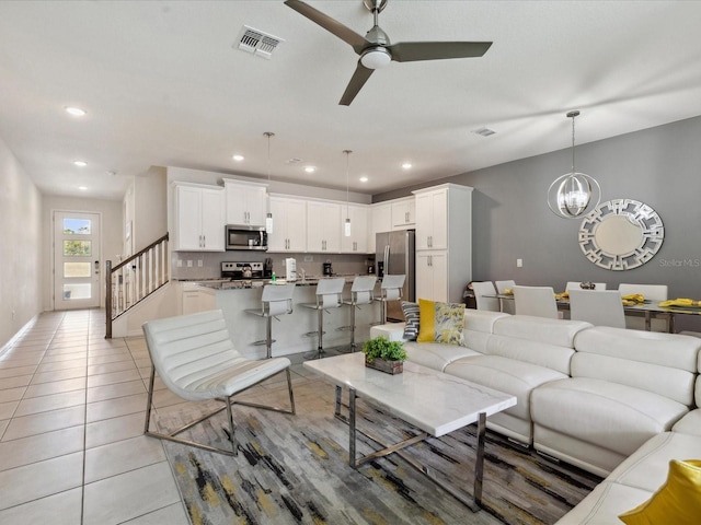 1632 Tropical Palms Cir, Kissimmee, FL 34747 - living room featuring a chandelier, light tile patterned floors, a ceiling fan, recessed lighting, and stairs