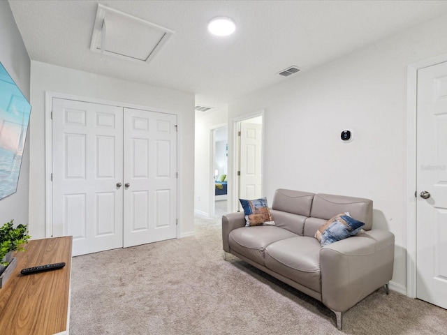 1632 Tropical Palms Cir, Kissimmee, FL 34747 - carpeted living room featuring attic access and baseboards