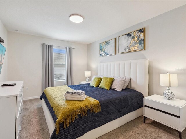 1632 Tropical Palms Cir, Kissimmee, FL 34747 - bedroom featuring light carpet and baseboards