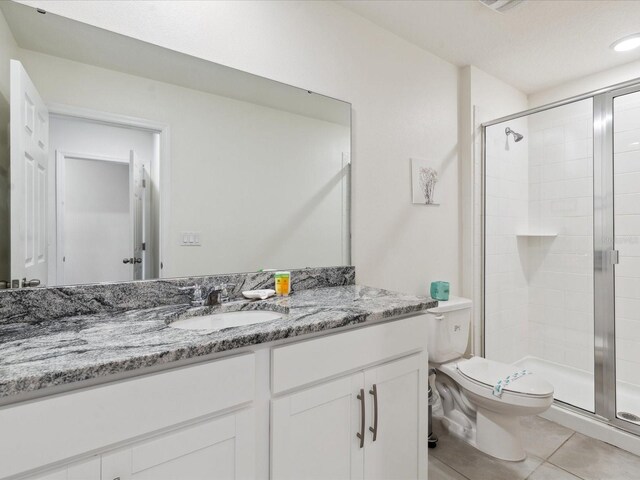1632 Tropical Palms Cir, Kissimmee, FL 34747 - full bath featuring a shower stall, toilet, tile patterned floors, and vanity