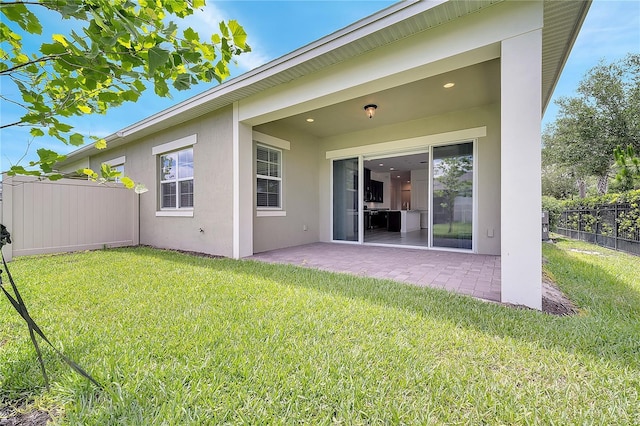 back of house with a patio and stucco siding