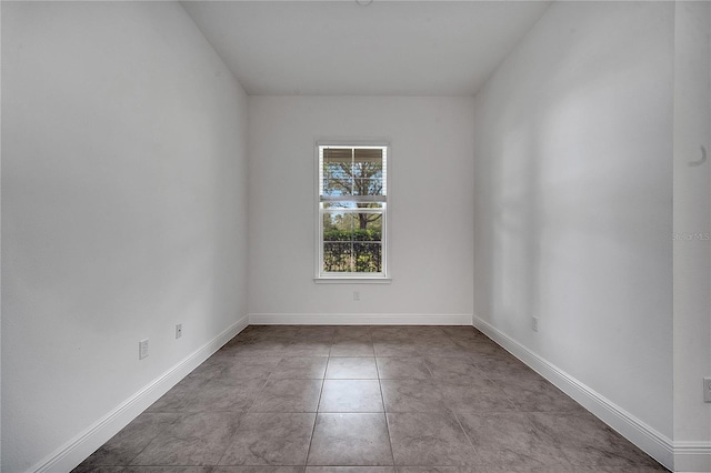 tiled empty room with baseboards