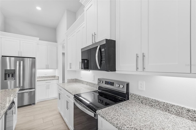 0 Overton St, Orlando, FL 32833 - kitchen with stainless steel appliances, white cabinetry, light stone counters, and recessed lighting