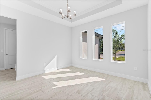 0 Overton St, Orlando, FL 32833 - unfurnished room featuring a chandelier, a tray ceiling, baseboards, and ornamental molding
