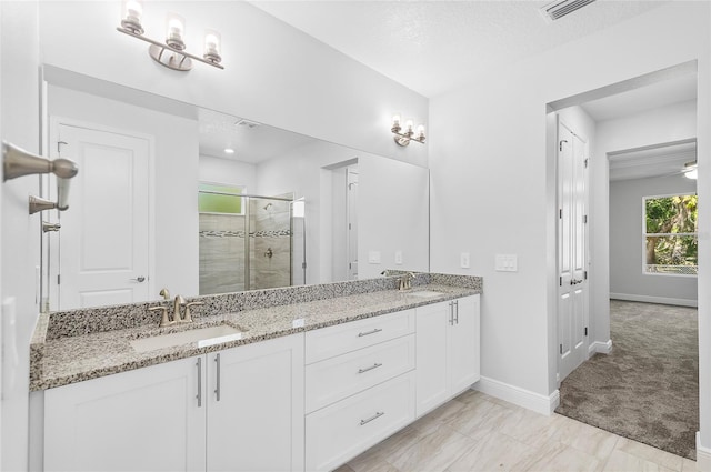 0 Overton St, Orlando, FL 32833 - bathroom with a stall shower, baseboards, and double vanity