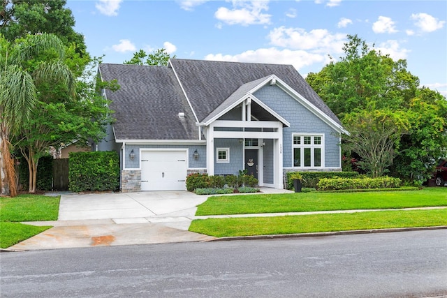 craftsman house with concrete driveway, an attached garage, and roof with shingles