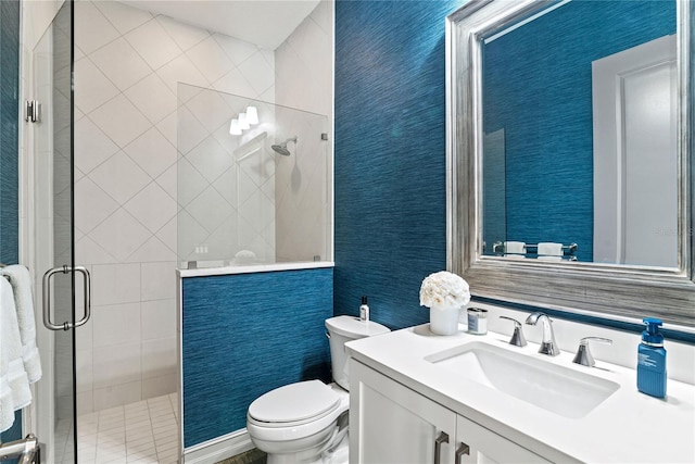 bathroom with toilet, a shower stall, and vanity