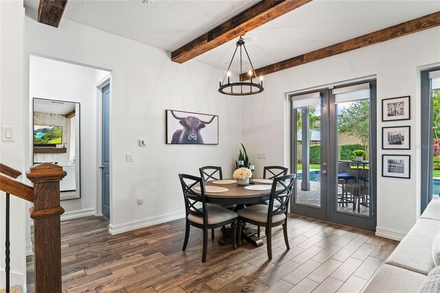 dining room with beam ceiling, dark wood-style floors, french doors, baseboards, and a chandelier
