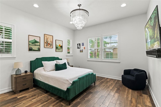 bedroom featuring dark wood finished floors, recessed lighting, a chandelier, and baseboards